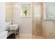 Modern bathroom featuring a glass-enclosed shower and sleek vanity with ample lighting at 7118 Hawks Harbor Cir, Bradenton, FL 34207