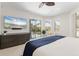 Primary bedroom boasts a dresser with TV and sliding glass doors to a screened patio at 7118 Hawks Harbor Cir, Bradenton, FL 34207