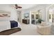 Well-lit primary bedroom with a king bed, sliding glass doors, and a comfy chair at 7118 Hawks Harbor Cir, Bradenton, FL 34207