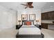 Bedroom featuring neutral decor, ceiling fan, built-in storage, and bedside tables with lamps at 7118 Hawks Harbor Cir, Bradenton, FL 34207