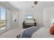 Bright bedroom with a ceiling fan, flatscreen television, and access to a private balcony at 7118 Hawks Harbor Cir, Bradenton, FL 34207