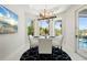 Bright dining area with a table and chairs, modern light fixture and views of the pool at 7118 Hawks Harbor Cir, Bradenton, FL 34207