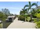 The backyard has a boat lift for easy access to the waterways, surrounded by lush landscaping at 7118 Hawks Harbor Cir, Bradenton, FL 34207