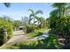 Scenic view of the private backyard dock area showcasing a walkway, boat lift and the lush landscaping at 7118 Hawks Harbor Cir, Bradenton, FL 34207