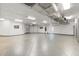 This spacious garage has custom storage, gray epoxy flooring, high ceilings, and room for multiple vehicles at 7118 Hawks Harbor Cir, Bradenton, FL 34207