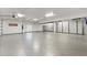 Spacious garage features custom storage cabinets, a gray epoxy floor, and ample room for multiple vehicles at 7118 Hawks Harbor Cir, Bradenton, FL 34207