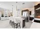 Open concept kitchen features a white quartz countertop, dark cabinets, and sleek pendant lighting at 7118 Hawks Harbor Cir, Bradenton, FL 34207