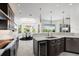 Bright kitchen with dark cabinetry, quartz countertops, and an open layout to the dining area at 7118 Hawks Harbor Cir, Bradenton, FL 34207