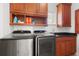Well-equipped laundry room with modern appliances, ample storage, and granite countertops at 7118 Hawks Harbor Cir, Bradenton, FL 34207