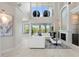 Spacious living room featuring soaring ceilings, fireplace, and ample natural light from large windows at 7118 Hawks Harbor Cir, Bradenton, FL 34207
