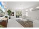 Bright living room with stylish furnishings, a large TV, and access to outdoor space at 7118 Hawks Harbor Cir, Bradenton, FL 34207