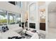 Bright living room with fireplace, white sectional, and soaring ceilings with second-story loft at 7118 Hawks Harbor Cir, Bradenton, FL 34207