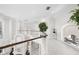 Open upper level loft featuring metal cable railings and custom art at 7118 Hawks Harbor Cir, Bradenton, FL 34207