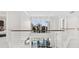 Upper-level hallway overlooking the pool featuring metal cable railings and a sitting area at 7118 Hawks Harbor Cir, Bradenton, FL 34207