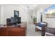 Home office featuring modern desk, comfortable seating, and view of outdoor space at 7118 Hawks Harbor Cir, Bradenton, FL 34207