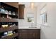 Pantry features shelving and sink with marble countertops, and a window providing natural light at 7118 Hawks Harbor Cir, Bradenton, FL 34207