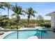 Private pool area surrounded by lush greenery and palm trees, creating a tropical paradise at 7118 Hawks Harbor Cir, Bradenton, FL 34207