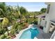 An aerial view of a private backyard oasis with a pool and surrounding lush landscaping at 7118 Hawks Harbor Cir, Bradenton, FL 34207