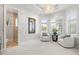 Bright sitting room filled with natural light through expansive windows and featuring comfortable seating at 7118 Hawks Harbor Cir, Bradenton, FL 34207