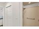 Well-lit bathroom with a walk-in shower and neutral tile, offering accessibility and style at 7155 Boca Grove Pl # 102, Lakewood Ranch, FL 34202
