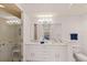 Bright bathroom with double vanity and glass shower, reflecting a clean and modern design at 7155 Boca Grove Pl # 102, Lakewood Ranch, FL 34202