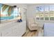 Comfortable bedroom featuring white furniture, shuttered windows, and a calming coastal view at 7155 Boca Grove Pl # 102, Lakewood Ranch, FL 34202