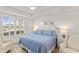 Bright bedroom with shuttered windows and a tray ceiling complemented by coastal decor at 7155 Boca Grove Pl # 102, Lakewood Ranch, FL 34202