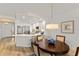 Open dining area connects seamlessly to a modern kitchen with white cabinets and stainless appliances at 7155 Boca Grove Pl # 102, Lakewood Ranch, FL 34202
