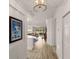 Hallway view into the condo revealing an open concept living area and abundant natural light at 7155 Boca Grove Pl # 102, Lakewood Ranch, FL 34202