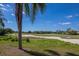 Beautiful golf course view showcasing lush green fairways and mature trees on a clear day at 7155 Boca Grove Pl # 102, Lakewood Ranch, FL 34202