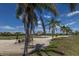 Scenic golf course view featuring towering palm trees and perfectly manicured greens at 7155 Boca Grove Pl # 102, Lakewood Ranch, FL 34202