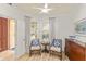 Bright sitting area with shuttered windows and stylish chairs at 7155 Boca Grove Pl # 102, Lakewood Ranch, FL 34202
