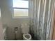 Bathroom featuring a standard toilet and shower with curtain at 7461 W Country Club N Dr # 201, Sarasota, FL 34243