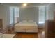 Well-lit bedroom featuring light hardwood floors, and large windows at 7461 W Country Club N Dr # 201, Sarasota, FL 34243