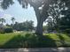 Community pool view framed by lush trees, creating a serene atmosphere at 7461 W Country Club N Dr # 201, Sarasota, FL 34243