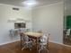 Cozy dining area with wood floors and views of the golf course at 7461 W Country Club N Dr # 201, Sarasota, FL 34243