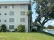 Building exterior view with lake and golf course in the background at 7461 W Country Club N Dr # 201, Sarasota, FL 34243