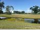 Scenic view of a golf course and water with a clear blue sky at 7461 W Country Club N Dr # 201, Sarasota, FL 34243
