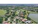Overhead shot showcasing residential homes surrounded by lush greenery, a pond, and a nearby golf course in this community at 7805 Allen Robertson Pl, Sarasota, FL 34240