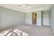Spacious bedroom with plush carpeting, a ceiling fan, and plenty of room for personalization at 7805 Allen Robertson Pl, Sarasota, FL 34240