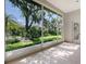 Covered lanai with a screened enclosure boasts scenic views of lush greenery and mature trees, creating a serene outdoor oasis at 7805 Allen Robertson Pl, Sarasota, FL 34240