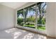Screened lanai showcases lush greenery and privacy with views of mature trees, providing a serene outdoor retreat at 7805 Allen Robertson Pl, Sarasota, FL 34240