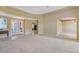 Open-concept living area featuring neutral walls, carpet and an archway that enhances the home's architectural charm at 7805 Allen Robertson Pl, Sarasota, FL 34240