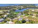 An aerial view shows the area and neighboring homes on the water with lush trees and vibrant landscapes at 80 Liles St, Terra Ceia, FL 34250