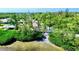 Aerial view of the property, showing the beach, a covered structure, and lush surrounding greenery at 80 Liles St, Terra Ceia, FL 34250