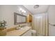Cozy bathroom with framed mirror, storage cabinet, and shower with curtain at 80 Liles St, Terra Ceia, FL 34250