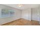 Bright bedroom features hardwood floors, a large window, and a ceiling fan at 80 Liles St, Terra Ceia, FL 34250