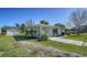 Charming single-story home with well-maintained landscaping, a covered front porch and long driveway at 80 Liles St, Terra Ceia, FL 34250