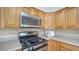 Kitchen with stainless steel oven, microwave, light backsplash and wood cabinets at 80 Liles St, Terra Ceia, FL 34250