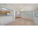 Living room with tile flooring and a view of the updated kitchen at 80 Liles St, Terra Ceia, FL 34250